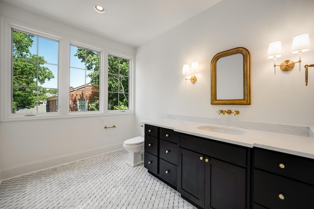 bathroom featuring vanity and toilet