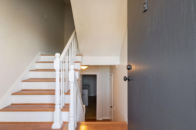 stairway with a textured ceiling