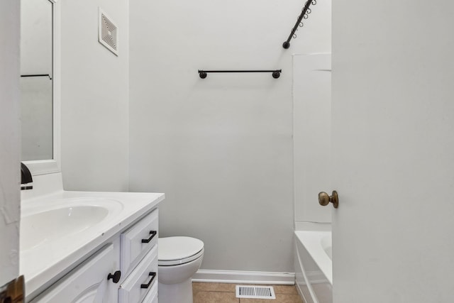 bathroom featuring vanity, tile patterned floors, and toilet