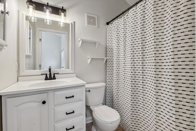 bathroom featuring a shower with curtain, vanity, and toilet