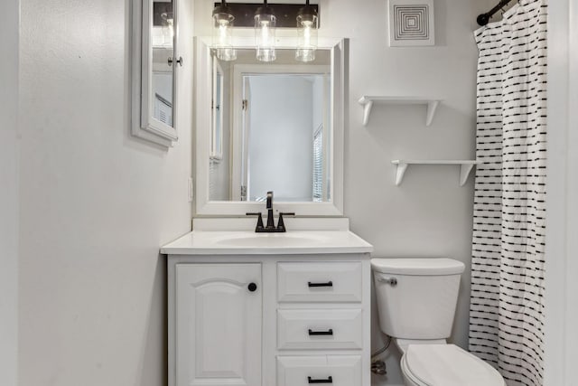 bathroom featuring vanity, curtained shower, and toilet