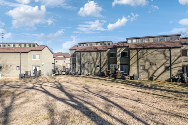 exterior space with cooling unit and a lawn