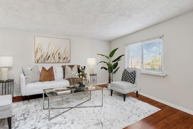 living room featuring hardwood / wood-style floors and a textured ceiling