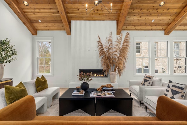 living room featuring a chandelier, lofted ceiling with beams, a fireplace, and wood ceiling