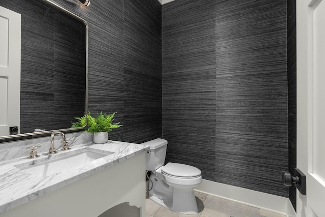 bathroom with tile patterned flooring, vanity, and toilet