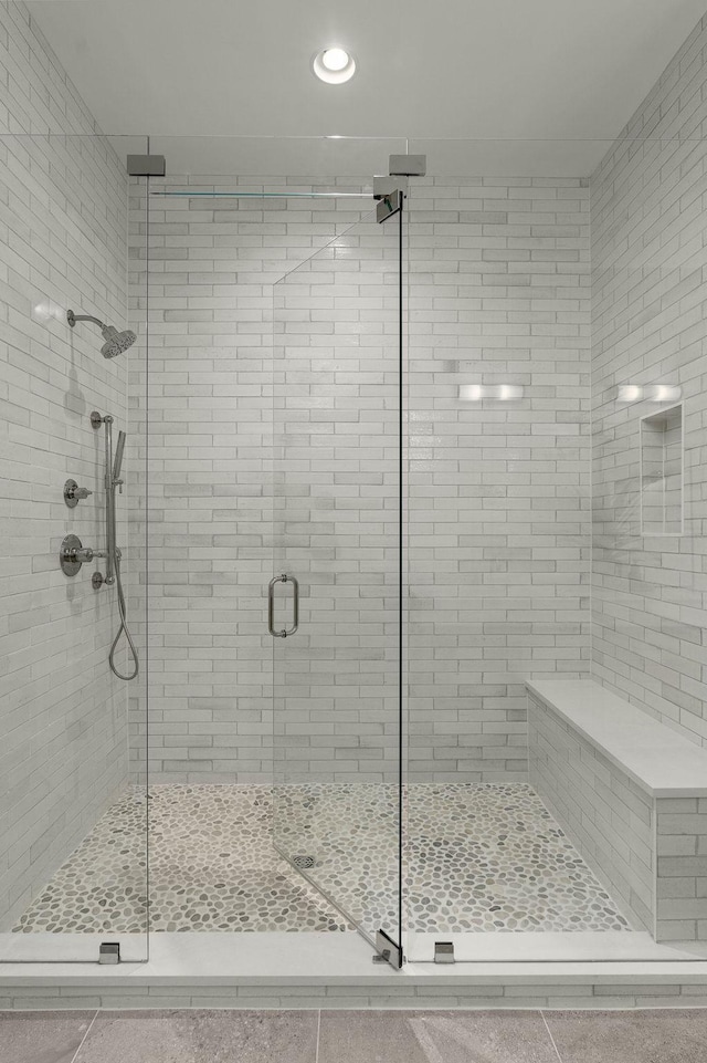 bathroom with tile patterned floors and an enclosed shower