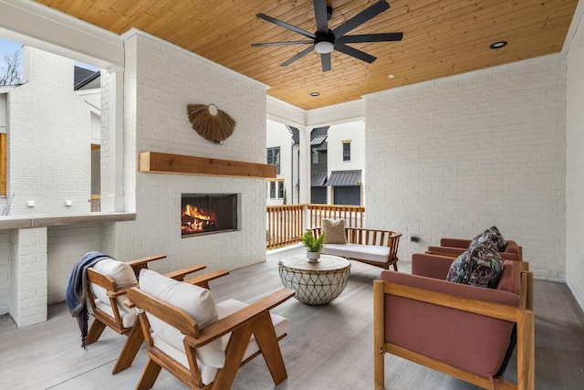 view of patio featuring an outdoor living space with a fireplace and ceiling fan