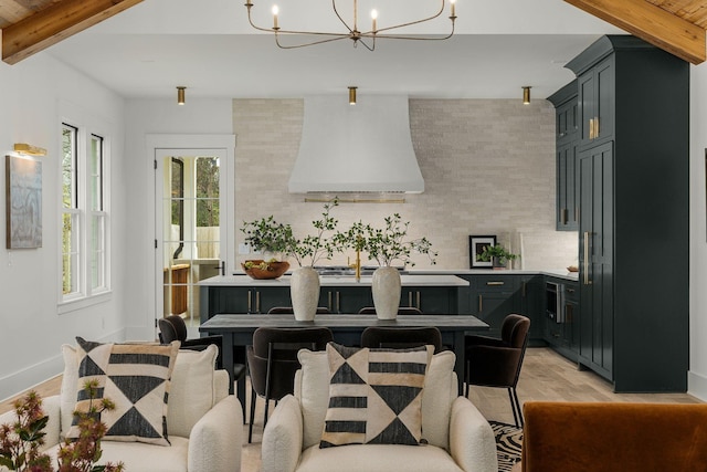 dining area featuring beamed ceiling, light hardwood / wood-style floors, and an inviting chandelier