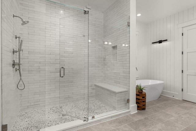 bathroom featuring tile patterned floors and shower with separate bathtub