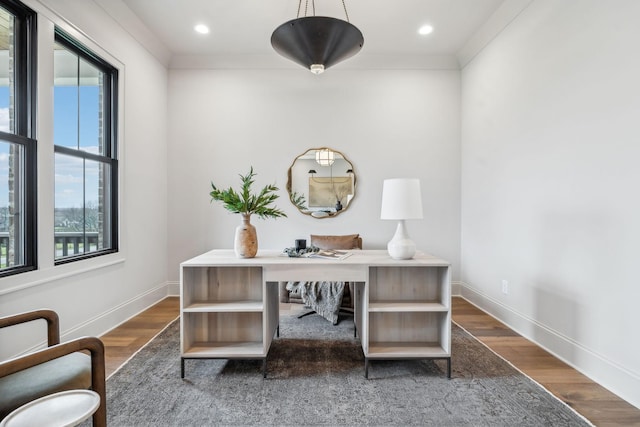 office featuring hardwood / wood-style floors, ornamental molding, and a healthy amount of sunlight