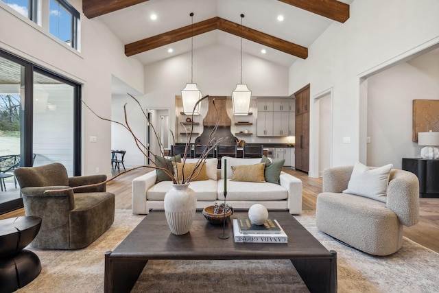 living room featuring beam ceiling, light wood-type flooring, and high vaulted ceiling