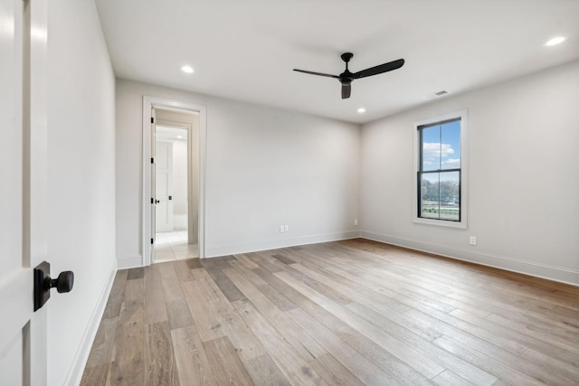 spare room with ceiling fan and light hardwood / wood-style floors