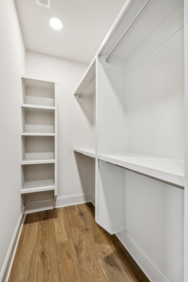 spacious closet featuring hardwood / wood-style flooring