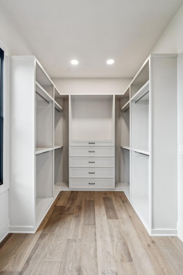 spacious closet featuring light hardwood / wood-style floors