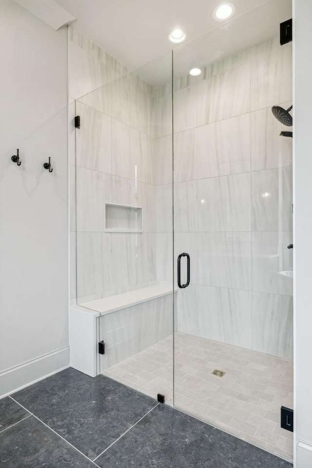 bathroom featuring tile patterned flooring and an enclosed shower