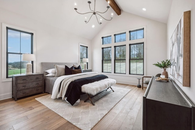 bedroom featuring beam ceiling, an inviting chandelier, high vaulted ceiling, and light hardwood / wood-style flooring