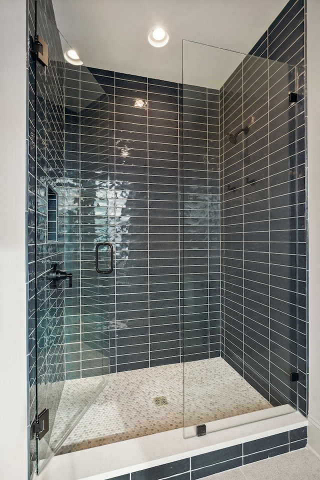 bathroom with a shower with shower door