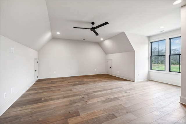 additional living space featuring ceiling fan, wood-type flooring, and vaulted ceiling