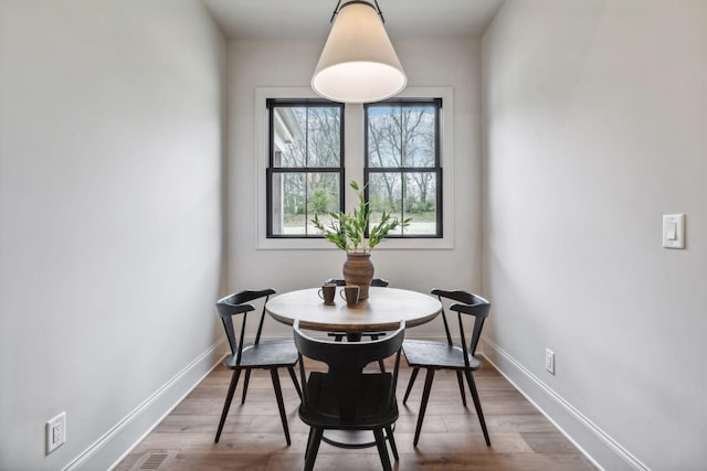 dining area with hardwood / wood-style flooring