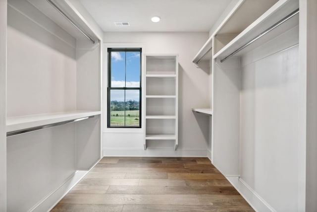 walk in closet featuring hardwood / wood-style flooring