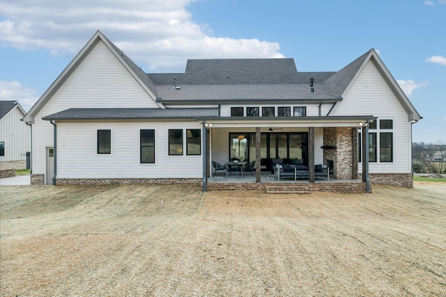 rear view of house featuring ceiling fan, a patio area, and an outdoor hangout area