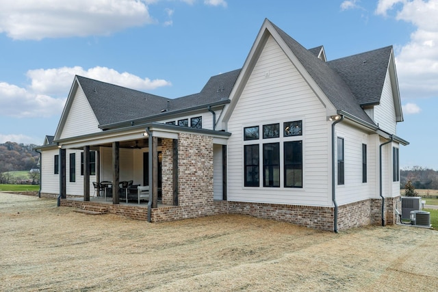 view of side of property featuring a patio and cooling unit