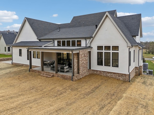 rear view of property with a patio area and central AC