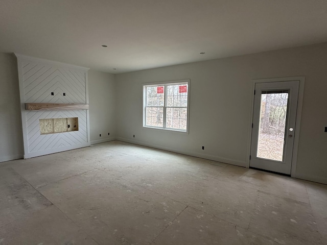 unfurnished living room featuring plenty of natural light