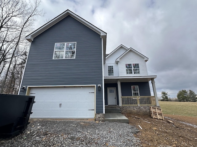 view of front of home with a porch and a garage