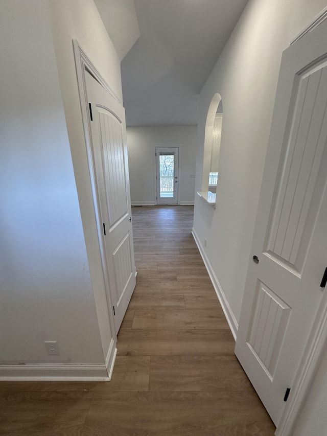 corridor with light hardwood / wood-style floors