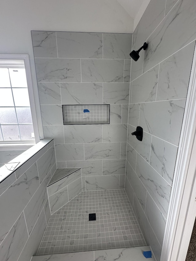 bathroom with a tile shower