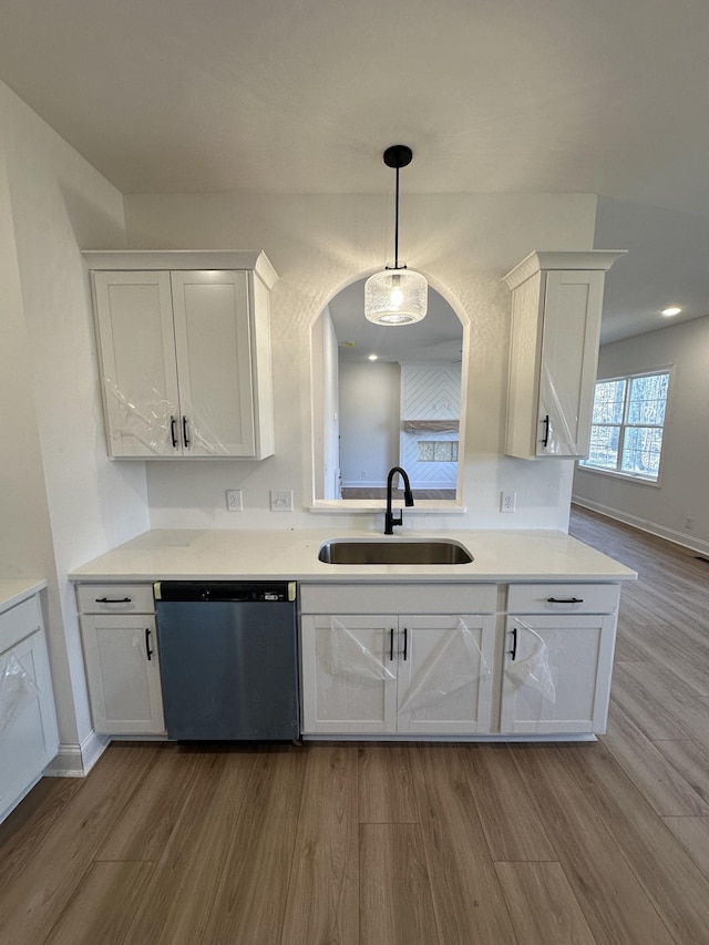 kitchen with sink, white cabinets, and dishwasher