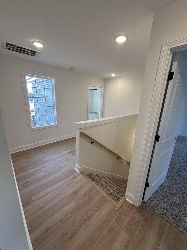 stairs with hardwood / wood-style flooring