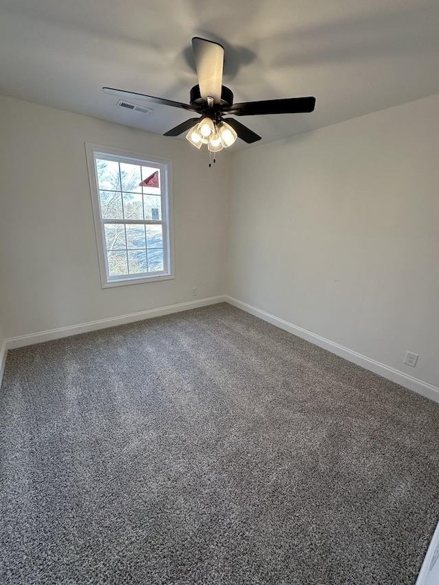 unfurnished room with ceiling fan and carpet