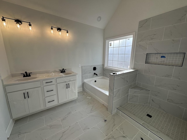 bathroom with vanity, a bathing tub, and vaulted ceiling