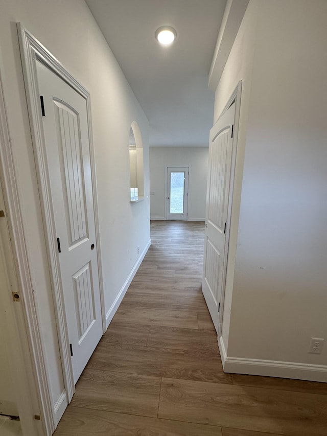 hall with light hardwood / wood-style floors