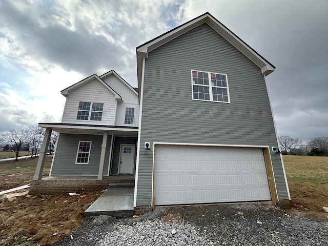 view of front of property with a garage and covered porch