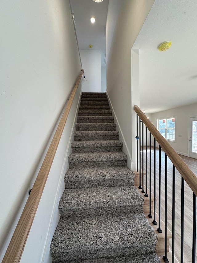 stairs featuring hardwood / wood-style floors