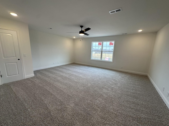 empty room with ceiling fan and carpet flooring