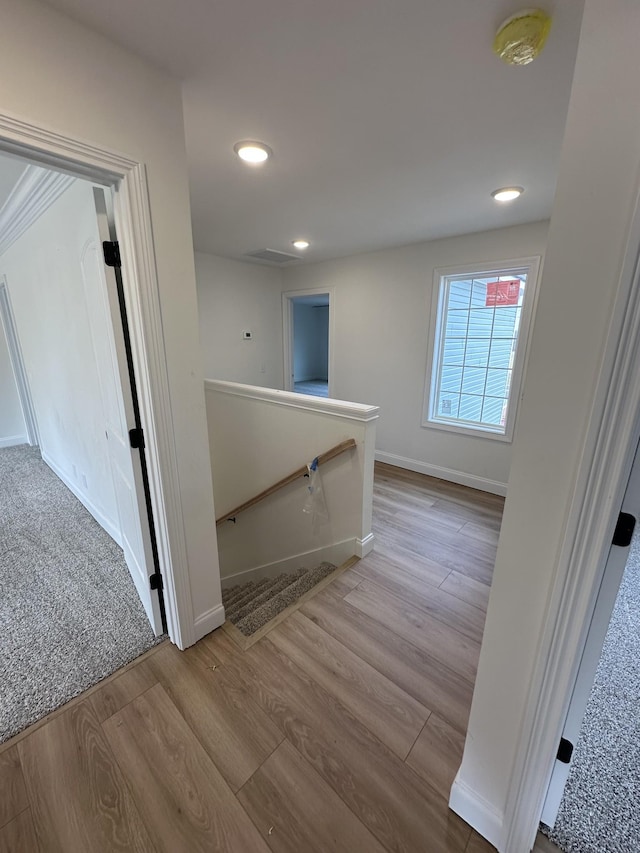 corridor with light hardwood / wood-style flooring