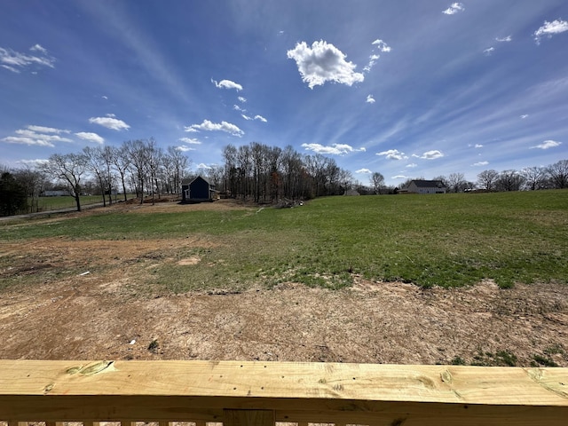 view of yard featuring a rural view and an outdoor structure