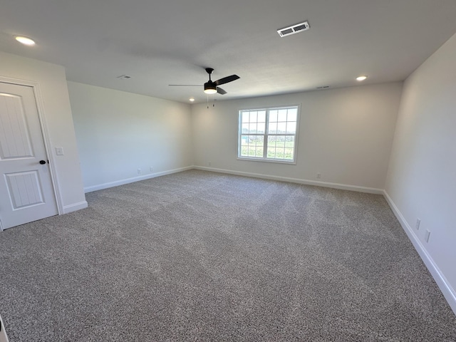 carpeted spare room featuring baseboards, ceiling fan, visible vents, and recessed lighting
