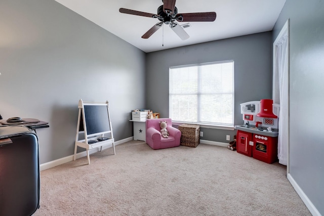 playroom featuring light colored carpet and ceiling fan