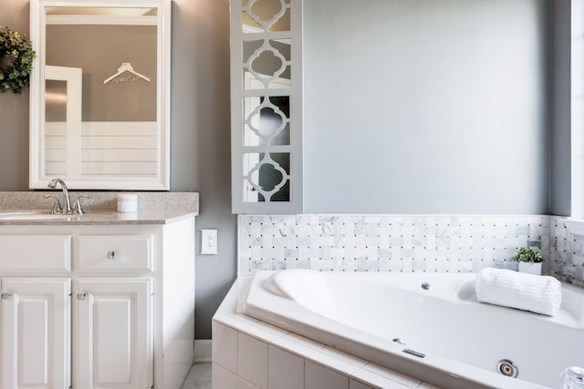 bathroom with vanity and a relaxing tiled tub