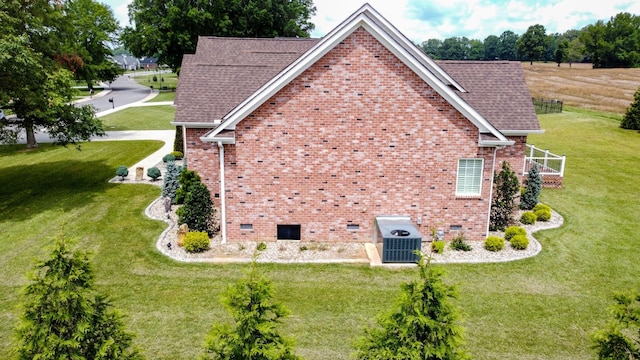 view of home's exterior featuring a yard and central AC unit