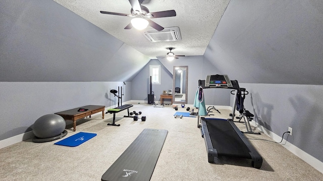 workout room with a textured ceiling, carpet floors, ceiling fan, and lofted ceiling