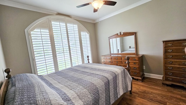 bedroom featuring multiple windows, ceiling fan, dark hardwood / wood-style flooring, and ornamental molding