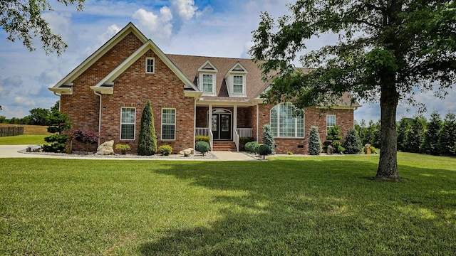 view of front of house with covered porch and a front lawn