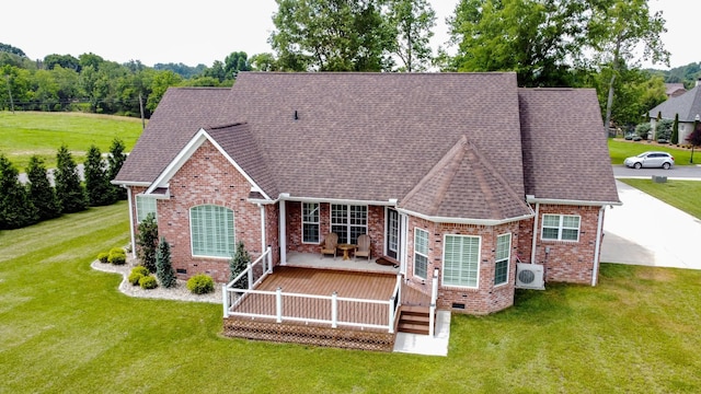 rear view of house with a yard, a wooden deck, and ac unit