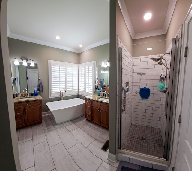 bathroom with vanity, separate shower and tub, and ornamental molding